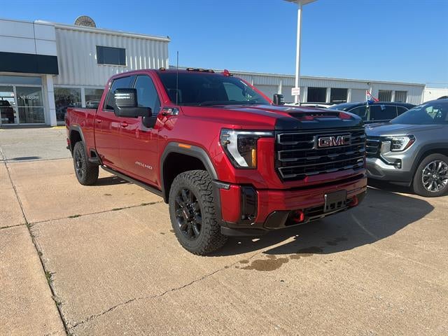 2026 GMC Sierra 2500 HD AT4 in Volcanic Red Tintcoat — front three-quarter view