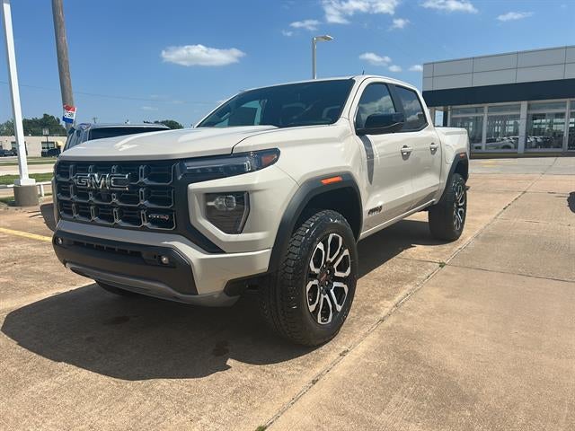 2026 GMC Canyon AT4 in Coastal Dune — front three-quarter view